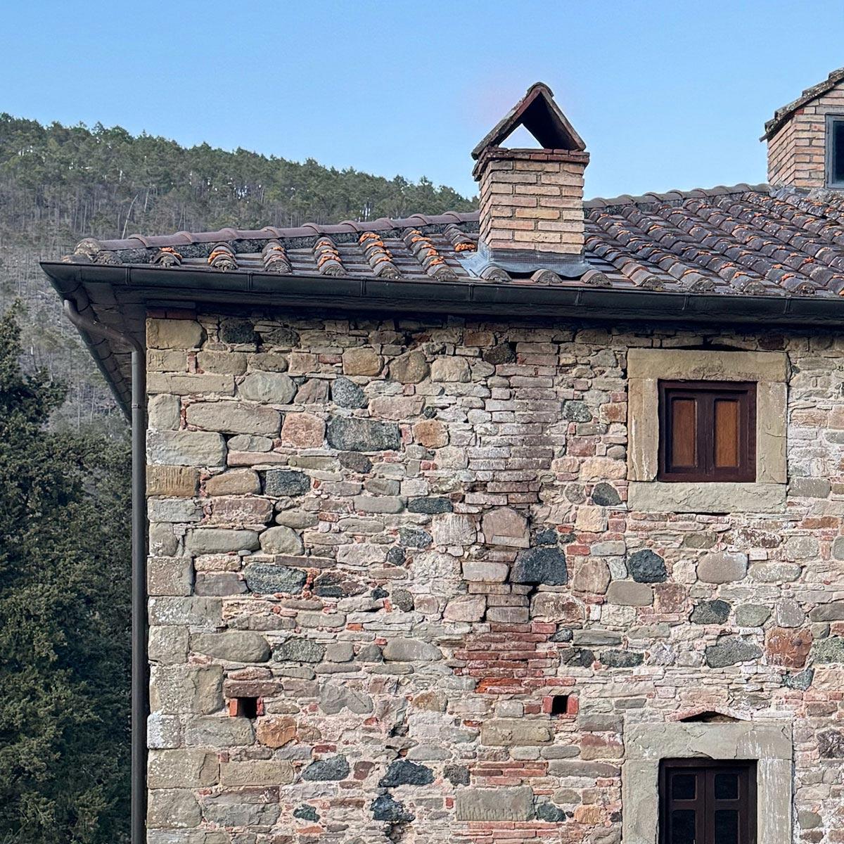 Stone walls and terracotta-tiled roof corner of the monastery